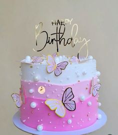 a pink and white cake with butterflies on it