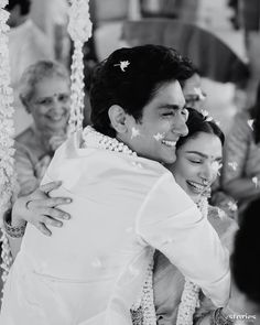 the bride and groom are hugging each other