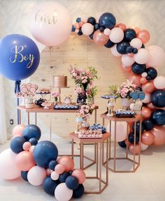 a table with balloons and desserts on it