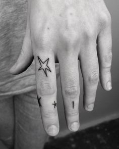 a person with a star tattoo on their left hand