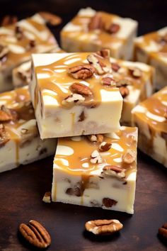 several pieces of cheesecake with pecans on the top and caramel drizzle