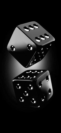 two black dices with holes in the middle on a black background, one is upside down