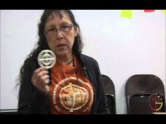 an older woman holding up a medal in front of her face