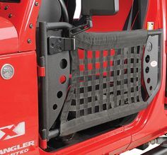 the back end of a red jeep with its doors open