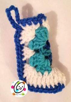 a crocheted blue and white boot hanging from a hook