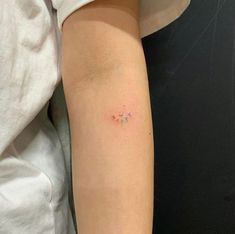 a person with a small tattoo on their arm