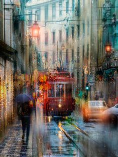 people with umbrellas are walking down the street in the rain