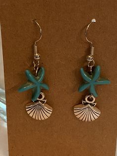 "Turquoise Starfish with Shell Charm Earrings Fun Under the Sea Dangle Earrings These pierced earrings feature silver charms of a Shell with turquoise starfish 1.75\" Dangle Earring Summer Beach Fun in the Sun!" Turquoise Jewelry With Starfish Charm For Gift, Turquoise Jewelry With Starfish Charm As Gift, Blue Drop Earrings With Dangling Charms, Silver Drop Earrings With Starfish Charm, Blue Starfish Charm Earrings For Gift, Starfish Charm Dangle Earrings For Jewelry Making, Handmade Silver Starfish Earrings, Turquoise Sterling Silver Earrings For Beach, Sterling Silver Starfish Charm Dangle Earrings