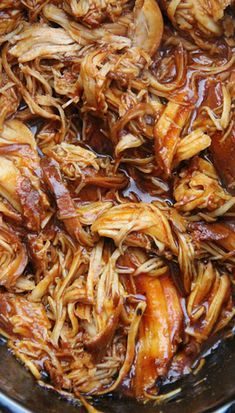 pulled pork is cooking in a pan on the stove