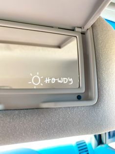 a mirror with the word down written on it in front of an airplane seat belt