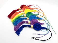 a group of crocheted tassels on a white surface with strings attached to them