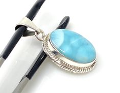 Larimar Gemstone Sterling Silver Pendant Jewelry at Wholesale Price. SIZE : 1.50” x 0.75” ( including Bail) WEIGHT : 8.8g GRADE : AAA GRADE GEMSTONE : NATURAL SMOOTH LARIMAR ORIGIN : DOMINICAN REPUBLIC TREATMENT: NO TREATMENT METAL : 925 STERLING SILVER SHAPE : OVAL HANDMADE **All Measurements are close approximations** LARIMAR : Larimar is the embodiment of the tranquil Sea and Sky energies. Its soft, soothing blues and calming turquoise is streaked with white patterns that resemble sunlight dancing beneath Caribbean waters. It brings the ancient wisdom of Atlantis and the healing power of dolphins to harmonize the body and soul. Larimar has a vitreous to silky luster. Larimar is a stone of great wisdom, exploration, and heightened understanding of the universe. This beautiful Handmade AA San Ramon, Silver Jewelry Pendant, Jewelry Sterling Silver, Dominican Republic, Bohemian Jewelry, White Patterns, Sterling Silver Pendant, Gemstone Pendant, Sterling Silver Pendants