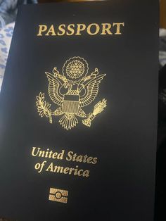 a black passport with the united states of america written on it's front cover