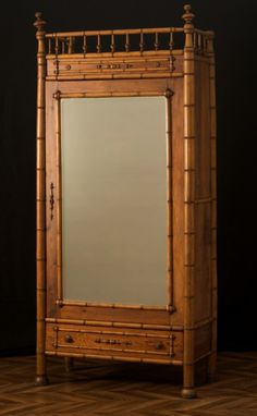 an old bamboo mirror is sitting on the floor