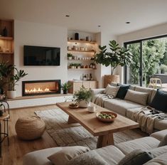 a living room filled with furniture and a fire place in the middle of it's wall