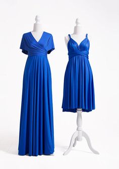 two mannequins dressed in blue dresses on white display stands, one wearing a short sleeved dress