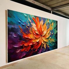 a large colorful painting hanging on the side of a wall