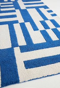 a blue and white rug on the floor