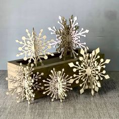 three wooden snowflakes sitting on top of a table