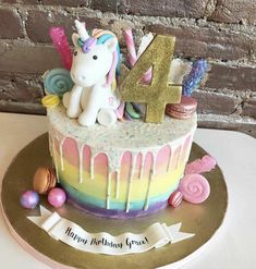 a birthday cake decorated with an unicorn and number 4 on it's icing