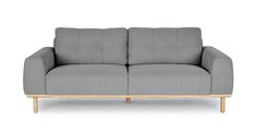 a gray couch sitting on top of a white floor next to a wooden frame and legs