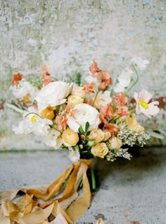 a bouquet of flowers sitting on the ground