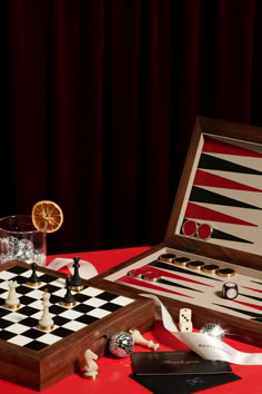 two pieces of chess are sitting on a table with other items in front of them