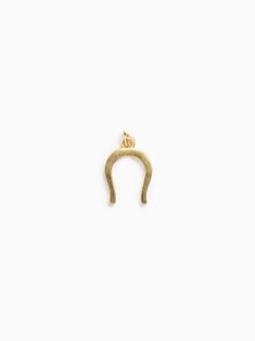 Since ancient times, U-Shaped Crescent charms have been used to draw luck and ward away mischief, wayward faeries, and those who wish you ill. Add a bit of fortune to your bracelet or necklace with this petite charm. Materials & Dimensions 14k plated gold over brass Spiritual Gold Charms For Good Luck, Spiritual Good Luck Gold Charms, Gold Engraved Horseshoe Jewelry, Gold Round Pendant Charms For Good Luck, Symbolic Yellow Gold Brass Charms, Yellow Gold Symbolic Charms For Good Luck, Gold Engraved Charms For Good Luck, Yellow Gold Symbolic Good Luck Charms, Good Luck Gold Charms With Engraving