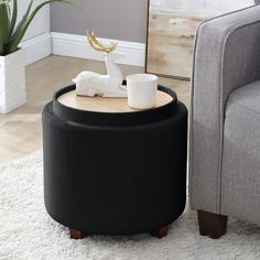 a coffee table with a cup on it next to a couch