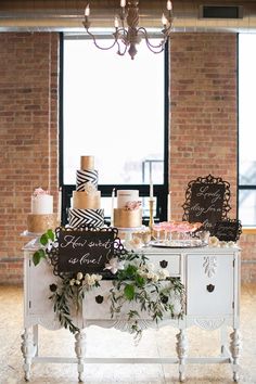 a table topped with lots of cake next to a window