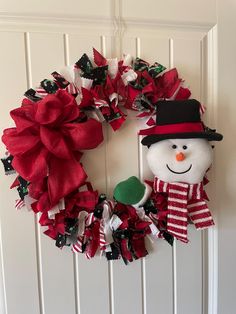 a christmas wreath with a snowman on it