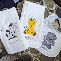 three personalized bibs with animals on them