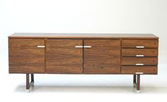 the sideboard is made out of wood and has four drawers, two doors and one drawer