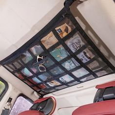 the inside of a vehicle with various items in it's back pocket and hanging from the ceiling