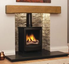 a wood burning stove in a living room next to a painting on the wall above it