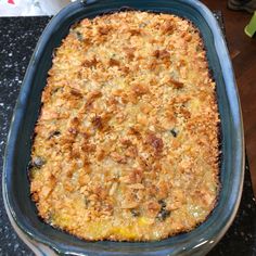 a casserole dish with meat and vegetables in it sitting on a counter top