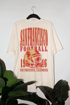 a san francisco football t - shirt hanging on a plant