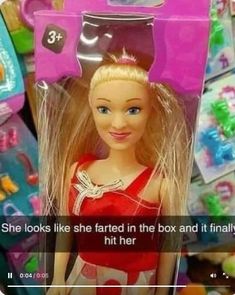 a barbie doll with blonde hair and blue eyes in a pink box that says she looks like she tarted in the box and it finally hit her