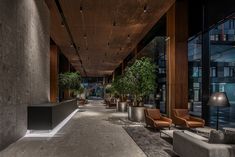 an empty lobby with couches and potted plants