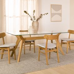 a glass table with four chairs around it