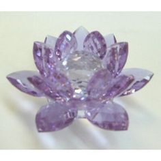 a purple crystal flower brooch sitting on top of a table