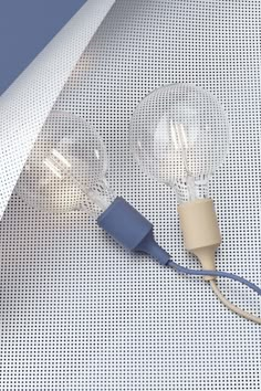 two light bulbs connected to each other on a white surface