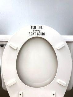 a white toilet seat with the words put the seat down on it