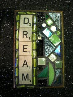 a box that has some type of letter tiles in it and the word dream spelled with letters