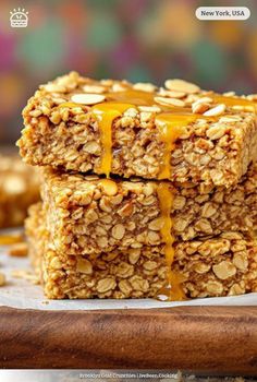 three granola bars stacked on top of each other with honey drizzled over them