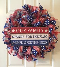 a red, white and blue wreath with the words our family stands for the flag and kneels for the cross