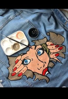 a woman's face painted on a jean jacket