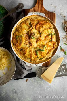 a casserole dish with cheese and herbs