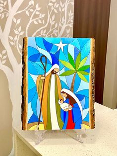 a stained glass nativity scene with the birth of jesus on it's side