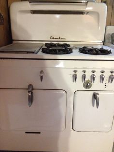 an old fashioned white stove with two burners